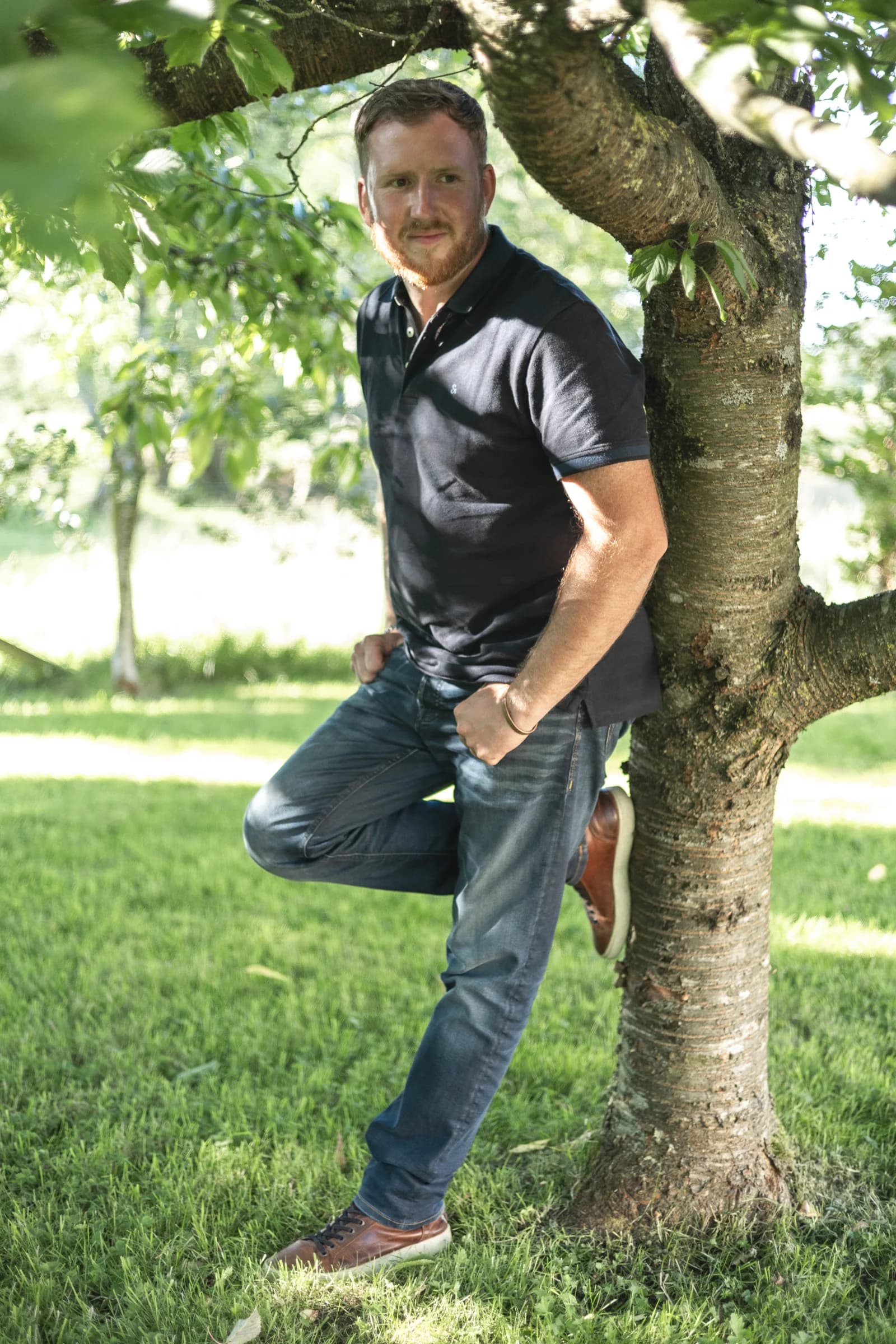 David Falconer smiling beside a tree