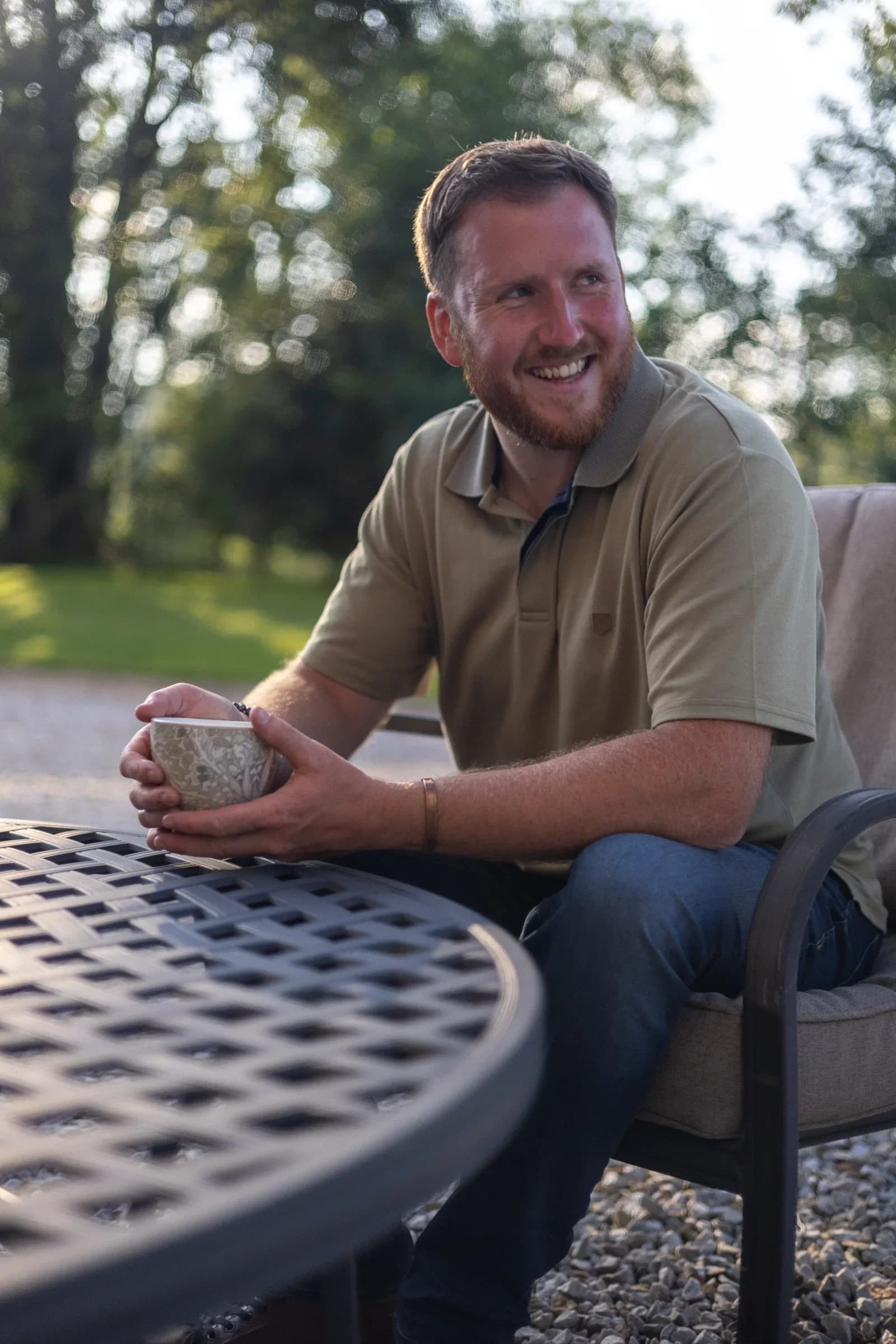 David Falconer sitting outdoors with a cup
